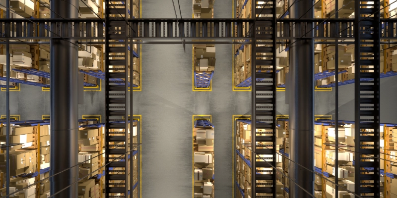 Vista aérea de pasillos automatizados en almacén con estanterías metálicas y sistemas robotizados